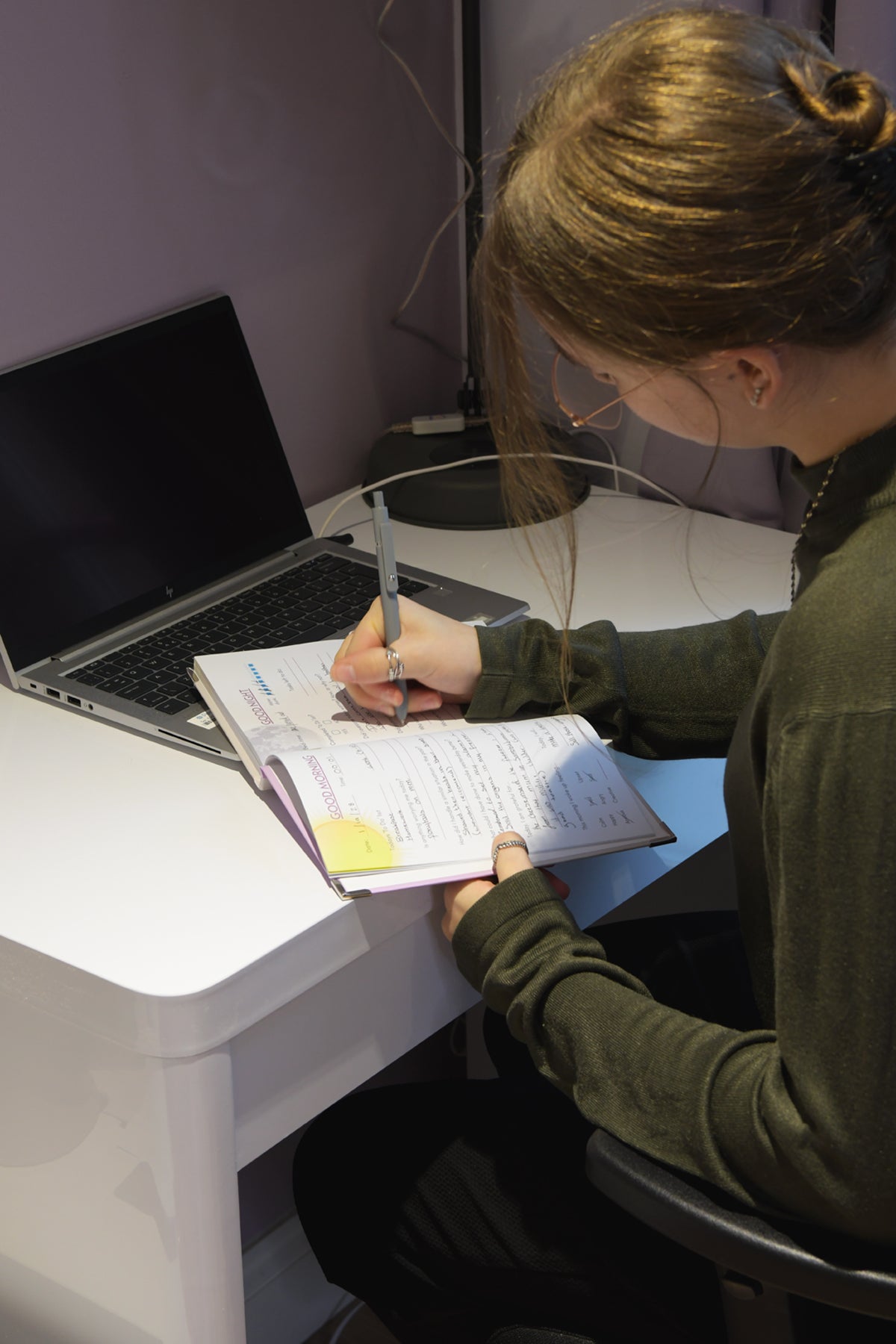 Student using her anxiety Journal to reduce the stress and anxiety from her day at college